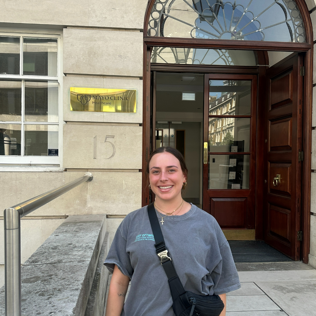 Edson College nursing student Carla Antypas poses next to the Mayo Clinic facility in London