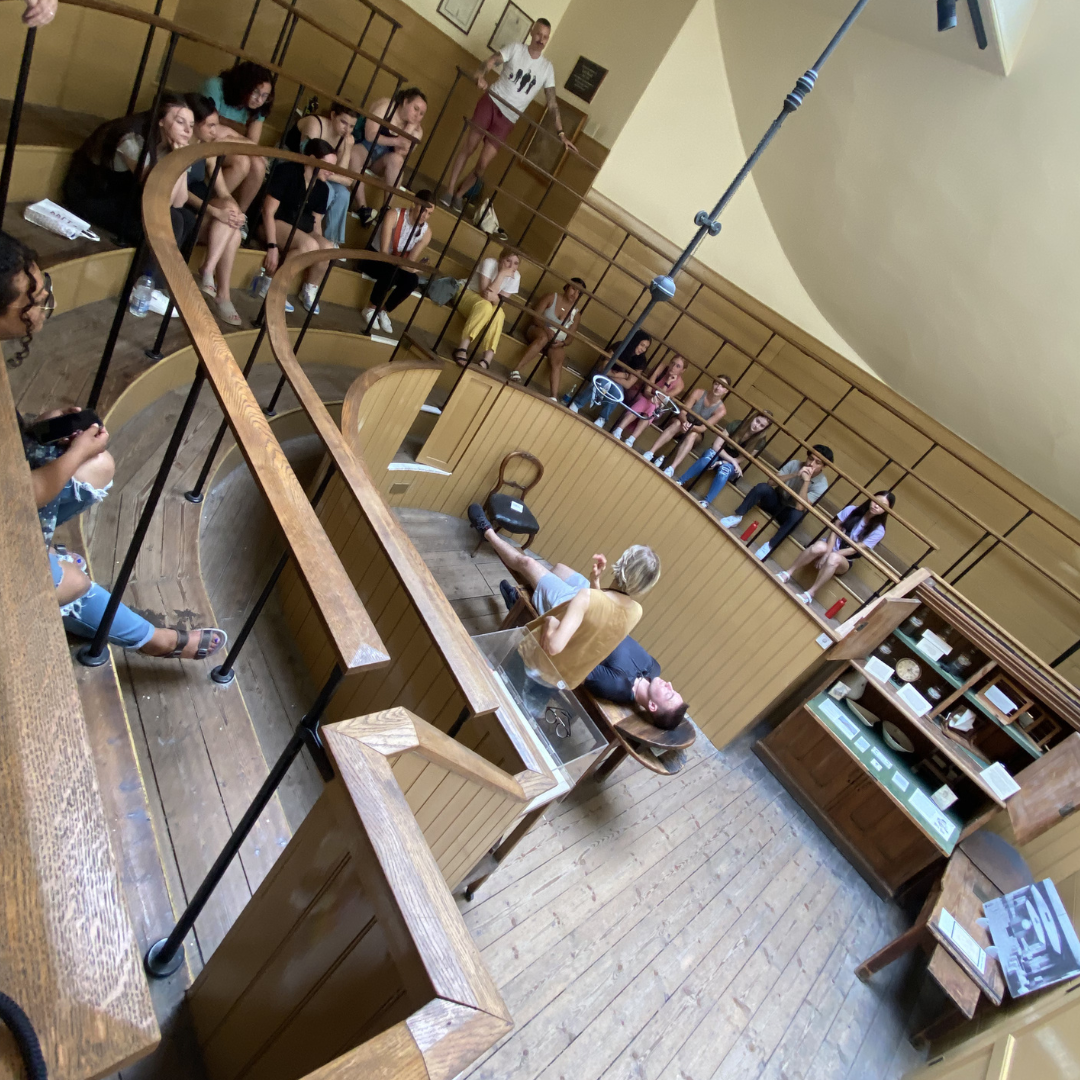 ASU students look on as a museum guide demonstrates how a procedure would go in an operating theatre in the 1800's.