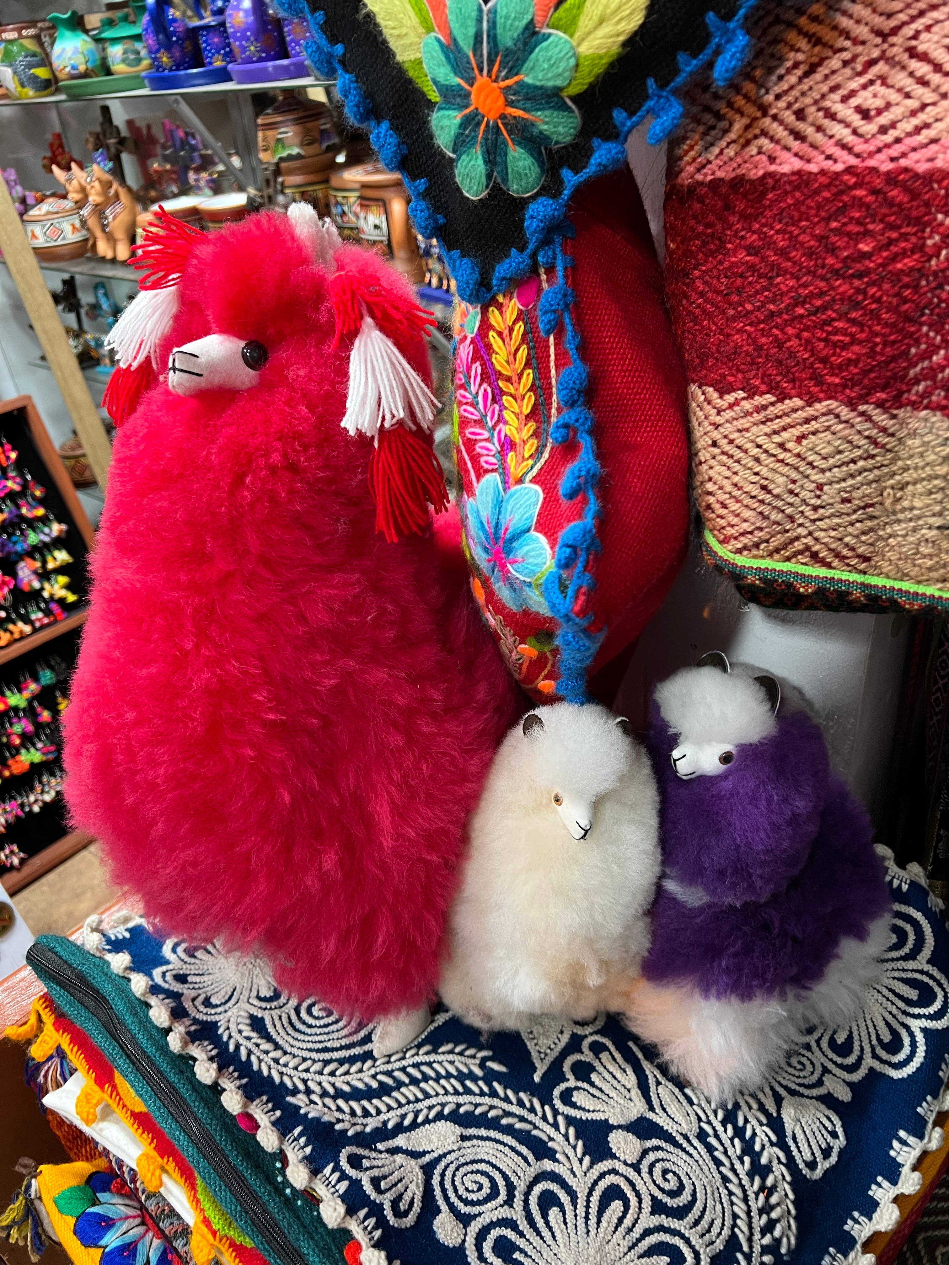 A stuffed llama for sale in a Cusco marketplace