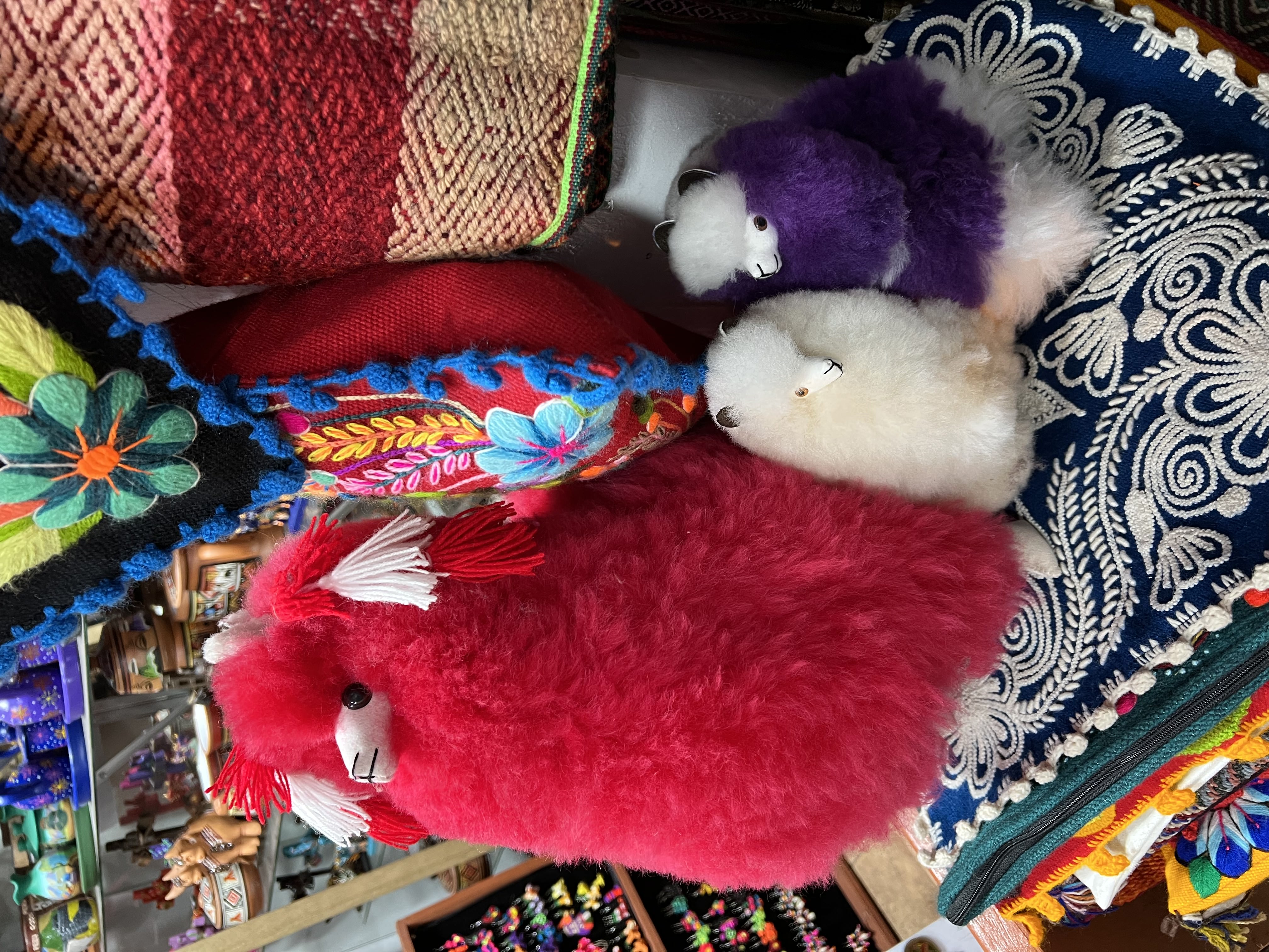 A stuffed llama for sale in a Cusco marketplace