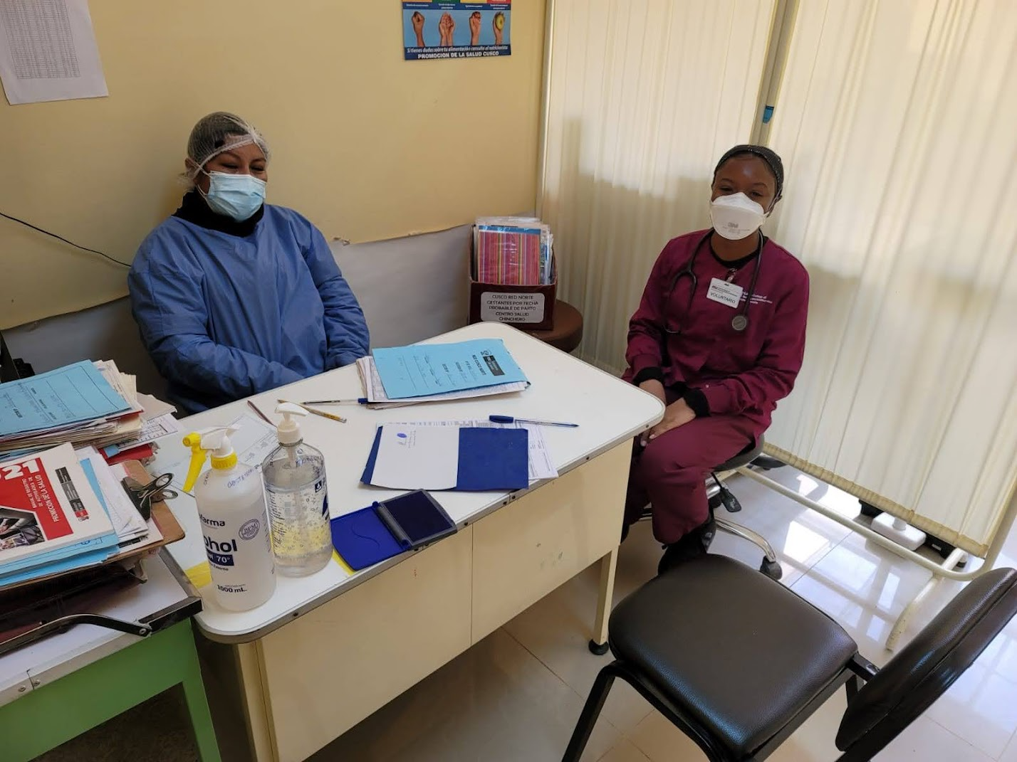ASU Student sits in a medical office next to a community health worker