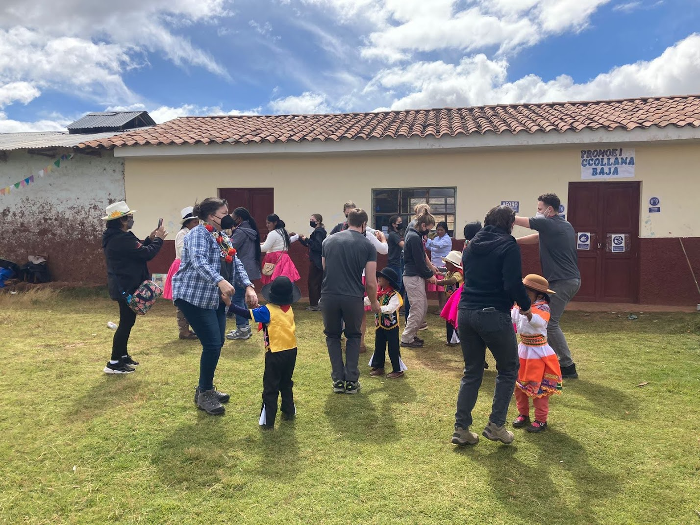 Students dance with native Peruvians during a welcome visit in the countryside