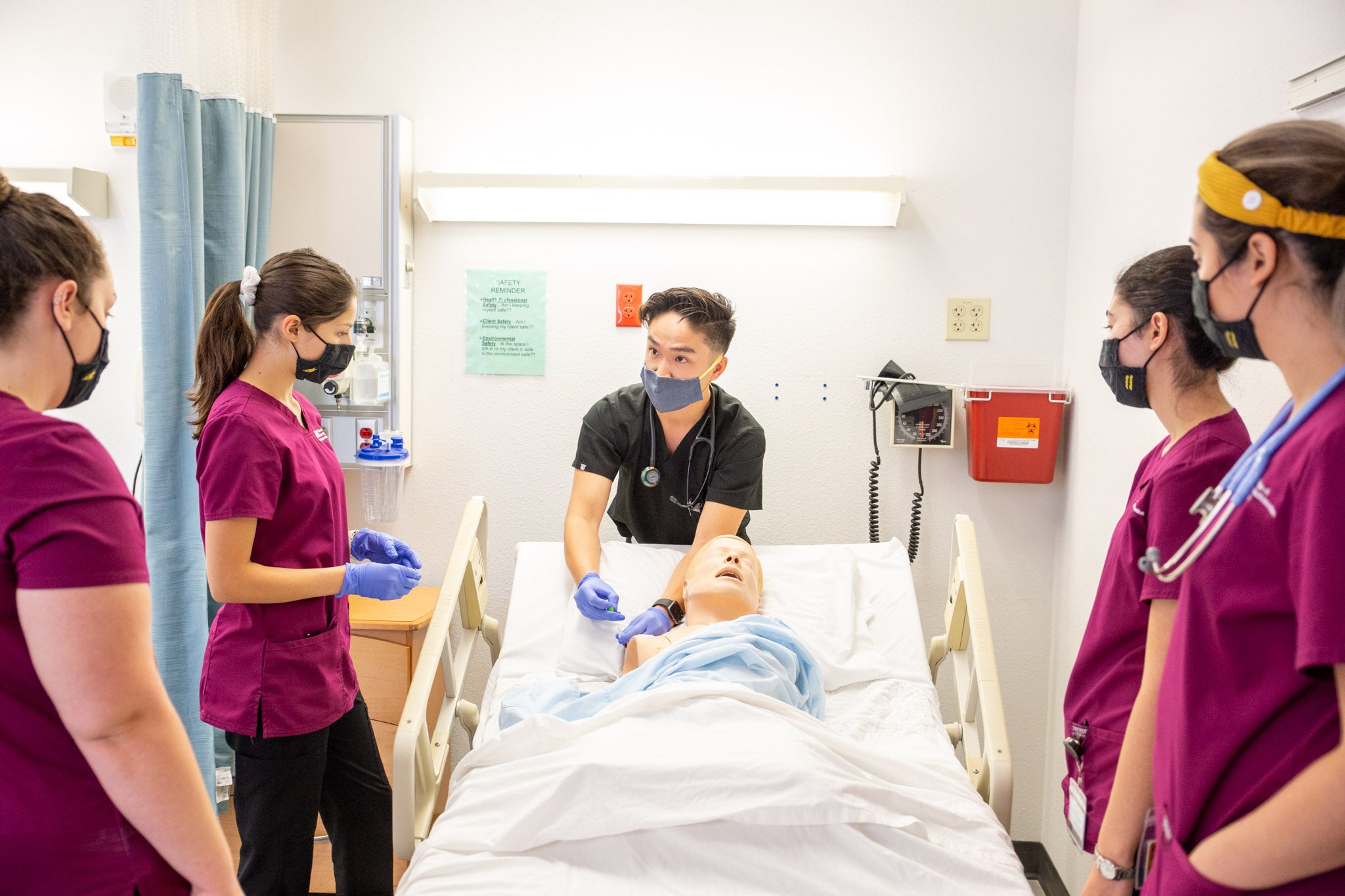 Edson College Faculty Associate Joseph Tran demonstrates proper injection site on a manikin for nursing students.