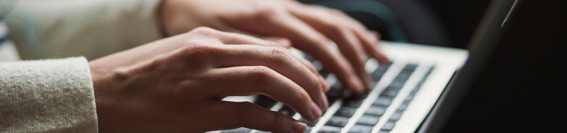 Hands on a laptop