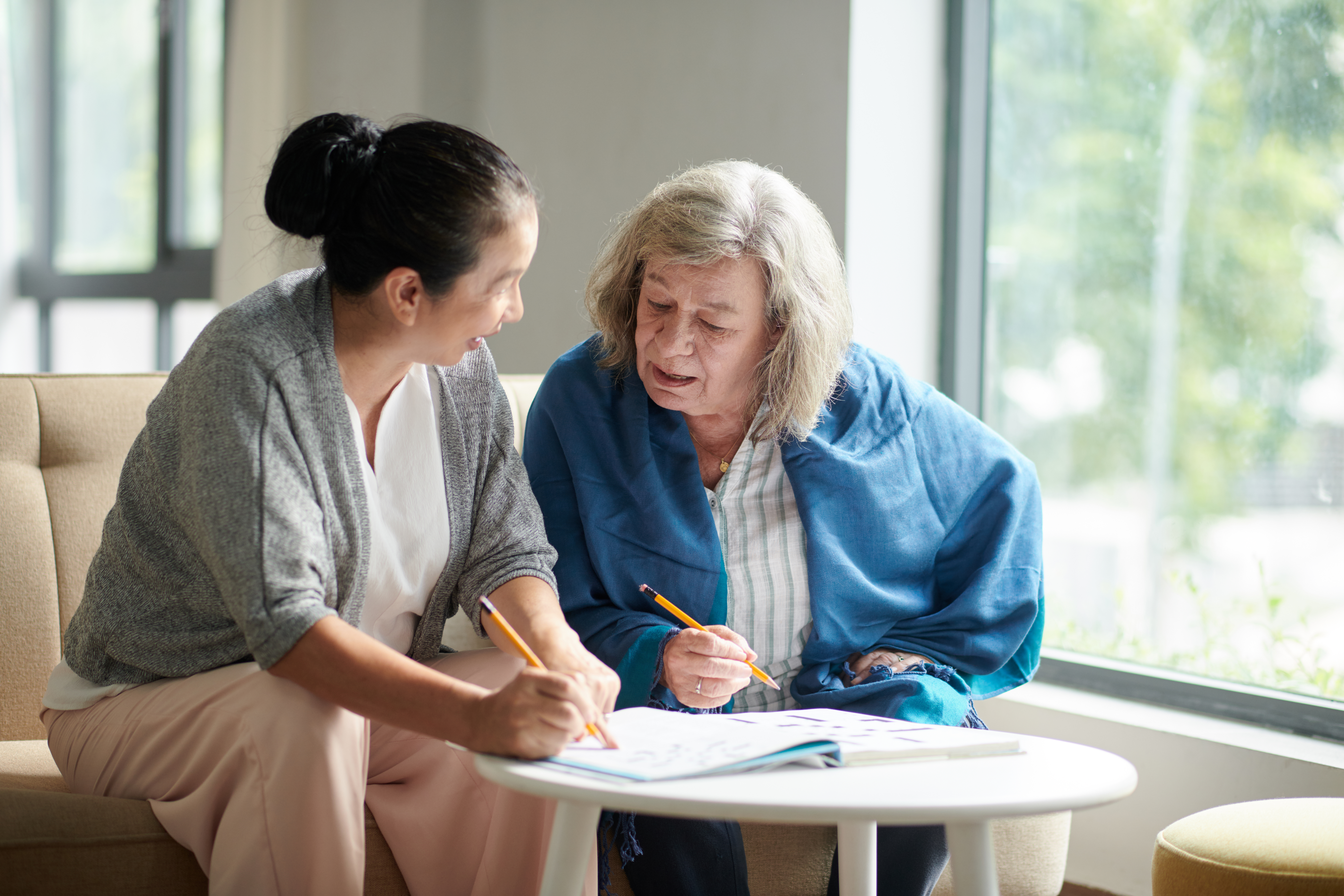 woman helping friend with crossword