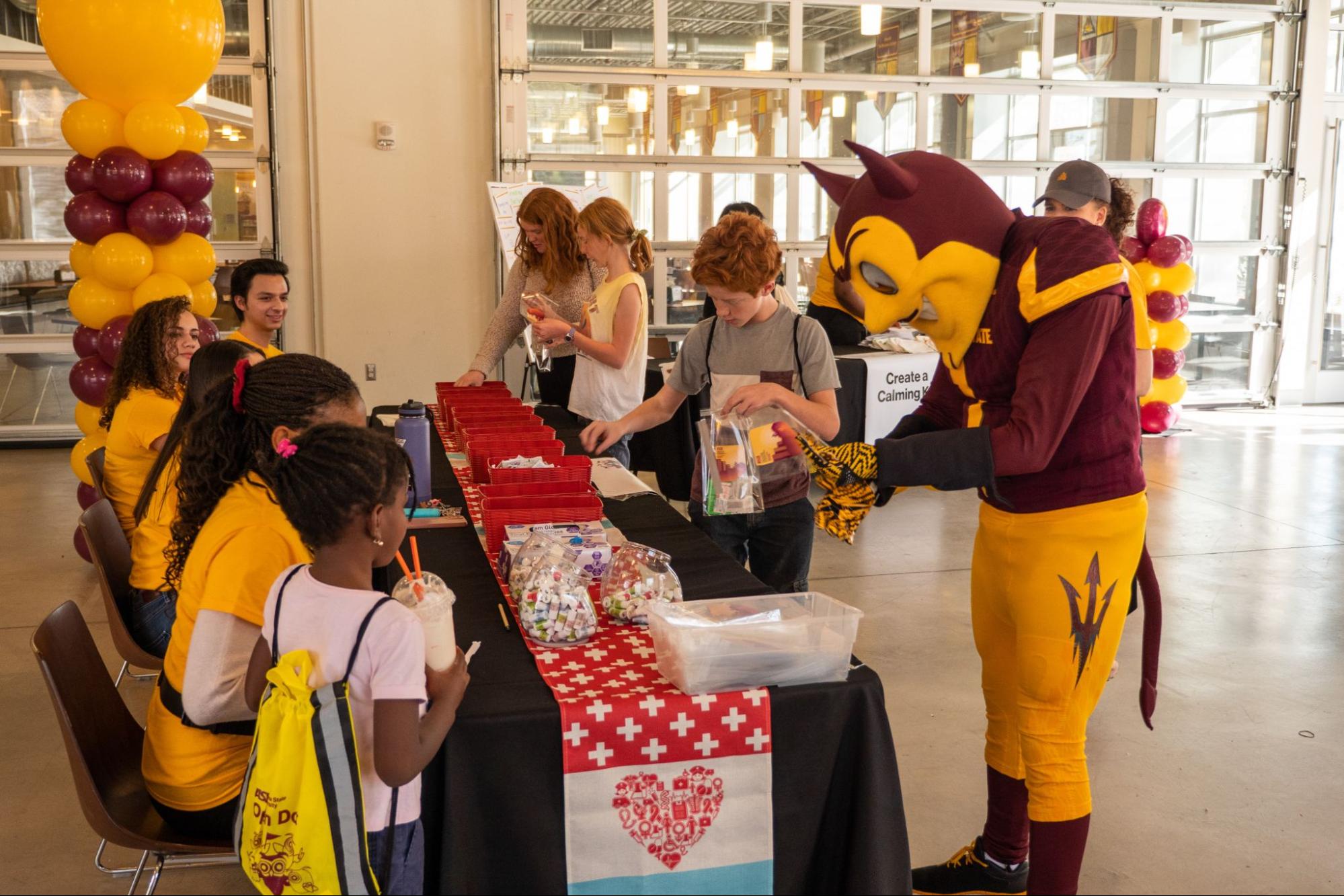 ASU Graduate and her family at a swag table