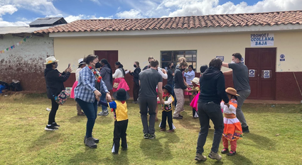 Students dance with native Peruvians during a welcome meeting.